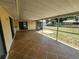 The screen enclosed lanai boasts a large tile floor, and an outdoor view at 21035 Exmore Ave, Port Charlotte, FL 33952