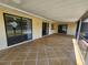 The outdoor lanai features a spacious tiled area with multiple entry doors at 21035 Exmore Ave, Port Charlotte, FL 33952