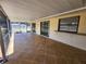 Wide screened-in patio with tile floors, sliders to indoors, and a pass-through window at 21035 Exmore Ave, Port Charlotte, FL 33952