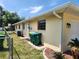 Exterior side of home with a fenced yard, featuring an AC Unit, and trashcans at 21035 Exmore Ave, Port Charlotte, FL 33952