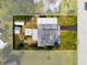 Aerial view of the property highlighting the home layout, yard, and sheds at 23491 Harper Ave, Punta Gorda, FL 33980