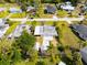 An aerial view of a home showcasing the overall property, sheds and the surrounding neighborhood at 23491 Harper Ave, Punta Gorda, FL 33980