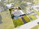 Aerial view of a single-story home with a driveway, carport and shed at 23491 Harper Ave, Punta Gorda, FL 33980
