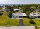 An aerial shot of the single-story home and property, with views of the water in the distance at 23491 Harper Ave, Punta Gorda, FL 33980