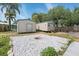 Backyard with two sheds and fire pit providing ample storage and entertainment space at 23491 Harper Ave, Punta Gorda, FL 33980