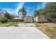 Spacious backyard with sheds, featuring concrete and rock areas for outdoor enjoyment at 23491 Harper Ave, Punta Gorda, FL 33980