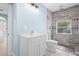 Bathroom with gray tiled shower, modern vanity, and natural light at 23491 Harper Ave, Punta Gorda, FL 33980