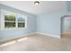 Comfortable light blue bedroom featuring a window with natural light and tile floors at 23491 Harper Ave, Punta Gorda, FL 33980