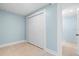 Light blue bedroom featuring a closet and tile floors at 23491 Harper Ave, Punta Gorda, FL 33980