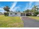 Charming single-story home with well-maintained lawn, driveway, and carport at 23491 Harper Ave, Punta Gorda, FL 33980