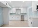 Bright kitchen featuring white cabinets, stainless steel appliances, and light countertops at 23491 Harper Ave, Punta Gorda, FL 33980