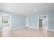Open living room with neutral tile, light blue walls and white trim at 23491 Harper Ave, Punta Gorda, FL 33980