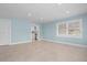 An open-concept living room with tiled floors, light blue walls, and white trim at 23491 Harper Ave, Punta Gorda, FL 33980