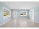 Bright and airy living room featuring tile floors and light blue walls at 23491 Harper Ave, Punta Gorda, FL 33980