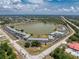 Aerial view of community surrounding the lake, showcasing the pool, landscaping, and ample parking available to residents at 25225 Rampart Blvd # 1801, Punta Gorda, FL 33983