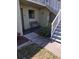 Condo exterior featuring green painted siding, white railings, and landscaping with a bench near the entrance at 25225 Rampart Blvd # 1801, Punta Gorda, FL 33983