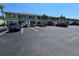 Two-story home featuring painted siding, white railings, palm trees, and ample parking at 25225 Rampart Blvd # 1801, Punta Gorda, FL 33983