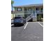Two-story home with parking, featuring painted siding, white railings, and well-maintained landscaping at 25225 Rampart Blvd # 1801, Punta Gorda, FL 33983