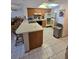 Bright kitchen featuring ample counter space, wood cabinets, modern appliances, and tiled floors at 25225 Rampart Blvd # 1801, Punta Gorda, FL 33983