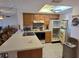 Bright kitchen featuring ample counter space, wood cabinets, modern appliances, and an adjacent dining area at 25225 Rampart Blvd # 1801, Punta Gorda, FL 33983