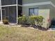 Enclosed screened patio surrounded by colorful landscaping at 25225 Rampart Blvd # 1801, Punta Gorda, FL 33983