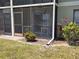 Enclosed screened patio with seating, surrounded by colorful landscaping at 25225 Rampart Blvd # 1801, Punta Gorda, FL 33983