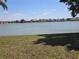Picturesque view of the tranquil lake and lush green lawn at 25225 Rampart Blvd # 1801, Punta Gorda, FL 33983