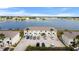 Aerial view showcasing building exteriors, parking, and lake in the background at 26290 Rampart Blvd # D, Punta Gorda, FL 33983
