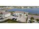 Aerial view showcasing building exteriors, parking, and lake in the background at 26290 Rampart Blvd # D, Punta Gorda, FL 33983