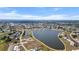 An aerial view of the neighborhood features a pond and shows the surrounding residential and golf community at 26290 Rampart Blvd # D, Punta Gorda, FL 33983