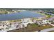 Aerial view features building exteriors, parking, and lake in the background at 26290 Rampart Blvd # D, Punta Gorda, FL 33983