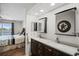 Stylish bathroom with double sinks, granite countertops, and decorative mirrors at 26290 Rampart Blvd # D, Punta Gorda, FL 33983