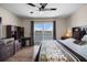 Bedroom with lake view, desk, and comfortable bed with floral accents at 26290 Rampart Blvd # D, Punta Gorda, FL 33983