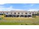 The exterior elevation shows several units with a second story balcony overlooking the manicured lawn at 26290 Rampart Blvd # D, Punta Gorda, FL 33983