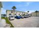 This exterior view shows assigned parking in front of the building, and a view of the adjacent lake at 26290 Rampart Blvd # D, Punta Gorda, FL 33983