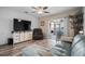 Comfortable living room with a large TV, plush sofa, and access to a sunroom at 26290 Rampart Blvd # D, Punta Gorda, FL 33983