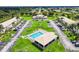 Aerial view of community pool and manicured green spaces creating an inviting neighborhood at 26485 Rampart Blvd # C1, Punta Gorda, FL 33983