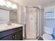 Bathroom featuring glass shower, modern vanity, and a toilet at 26485 Rampart Blvd # C1, Punta Gorda, FL 33983