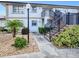 Well-maintained two-story condo building with lush landscaping and stairs leading to the upper units at 26485 Rampart Blvd # C1, Punta Gorda, FL 33983