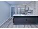 Updated kitchen with white cabinets, stainless appliances, and a large island with seating at 26485 Rampart Blvd # C1, Punta Gorda, FL 33983