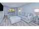 Cozy living room featuring comfortable seating, modern decor, and plenty of natural light at 26485 Rampart Blvd # C1, Punta Gorda, FL 33983