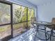 This patio features a table, chairs, and a screen to keep the bugs out while you eat at 26485 Rampart Blvd # C1, Punta Gorda, FL 33983