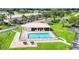 Community pool featuring a spacious sun deck, lounge chairs, and lush landscaping, perfect for relaxation at 26485 Rampart Blvd # C1, Punta Gorda, FL 33983