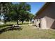 Spacious backyard with mature trees and well, creating a serene outdoor retreat with ample space for relaxation and recreation at 29211 Picador St, Punta Gorda, FL 33982