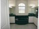 Elegant bathroom featuring a deep soaking tub, dual vanities, and lots of lighting at 29211 Picador St, Punta Gorda, FL 33982