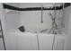Accessible bathtub with safety bars and handheld shower head in a tiled bathroom at 29211 Picador St, Punta Gorda, FL 33982