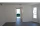 Empty bedroom with gray concrete floors and an en-suite bathroom with jacuzzi tub visible through the doorway at 29211 Picador St, Punta Gorda, FL 33982