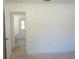 Bedroom featuring neutral paint, doorway to a bathroom, and ample natural light at 29211 Picador St, Punta Gorda, FL 33982