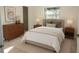 Stylishly furnished bedroom features neutral colors and an outside view through the window at 29211 Picador St, Punta Gorda, FL 33982