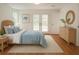 This cozy bedroom features a comfortable bed, wood floors, and a double door exit to the yard at 29211 Picador St, Punta Gorda, FL 33982